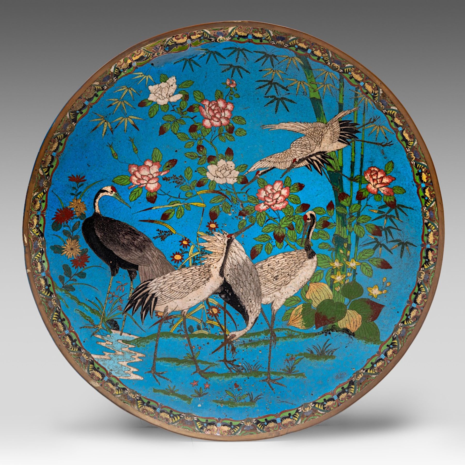 A large Japanese cloisonne enamelled plate with cranes, late Meiji (1868-1912), dia 61 cm
