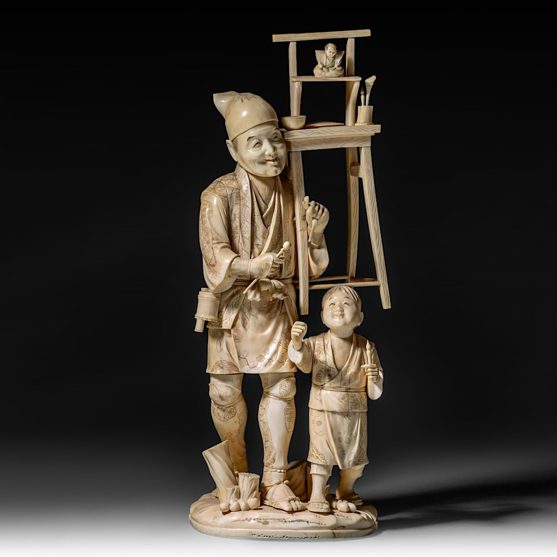 A large Japanese walrus ivory okimono of an artisan with his son, Meiji period (1868-1912), H 46,5 -