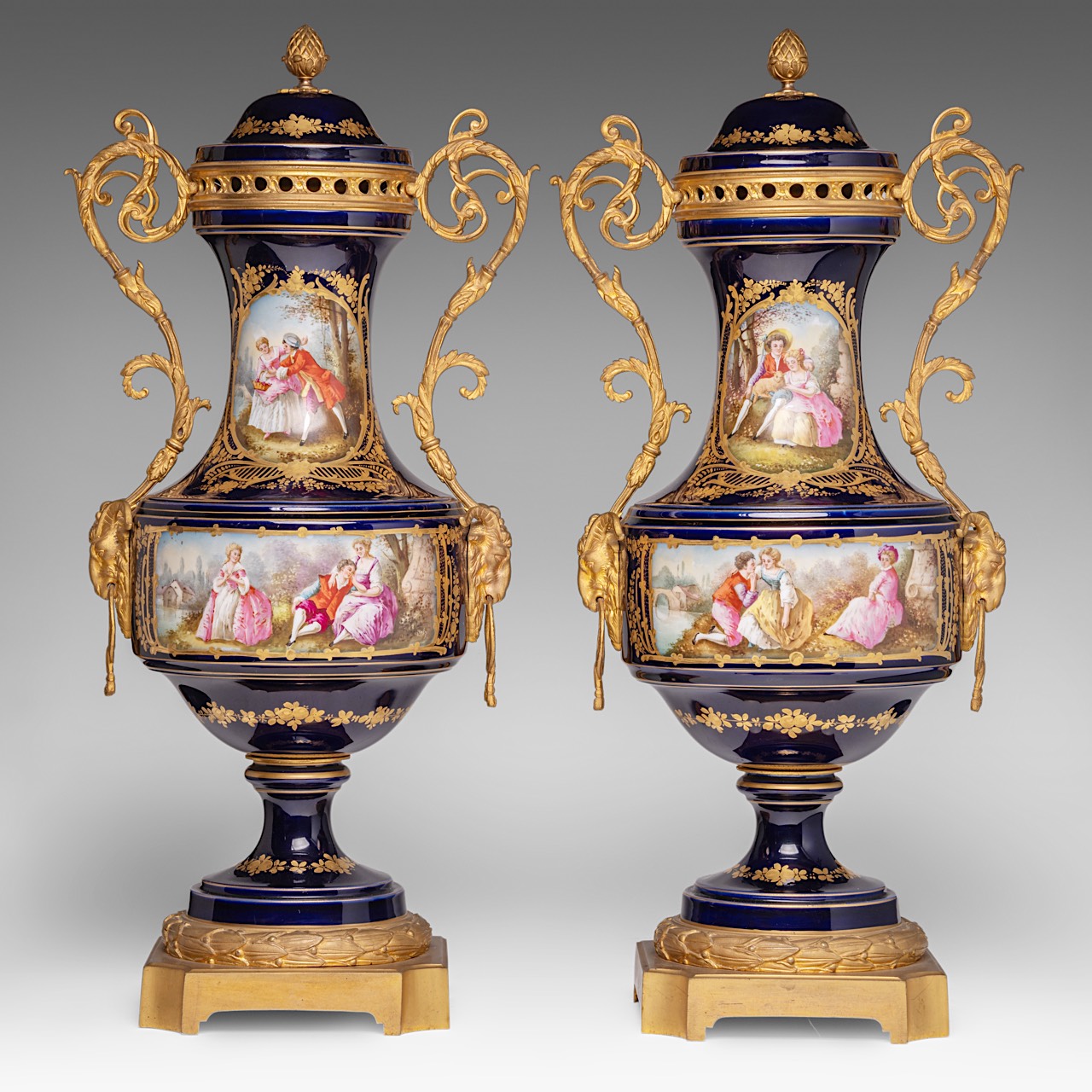 A pair of blue royale ground Sevres vases with hand-painted gallant scenes and gilt bronze mounts, H
