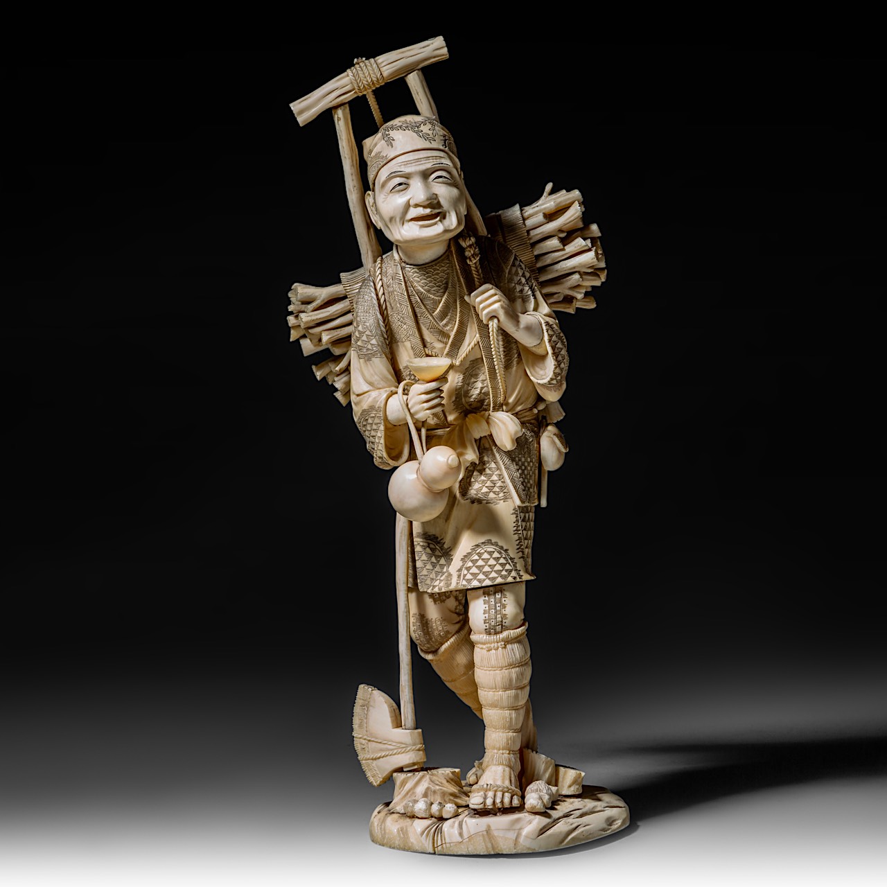 A large Japanese walrus ivory okimono of a wood gatherer, Meiji period (1868-1912), H 38 cm - 2248g - Image 2 of 9