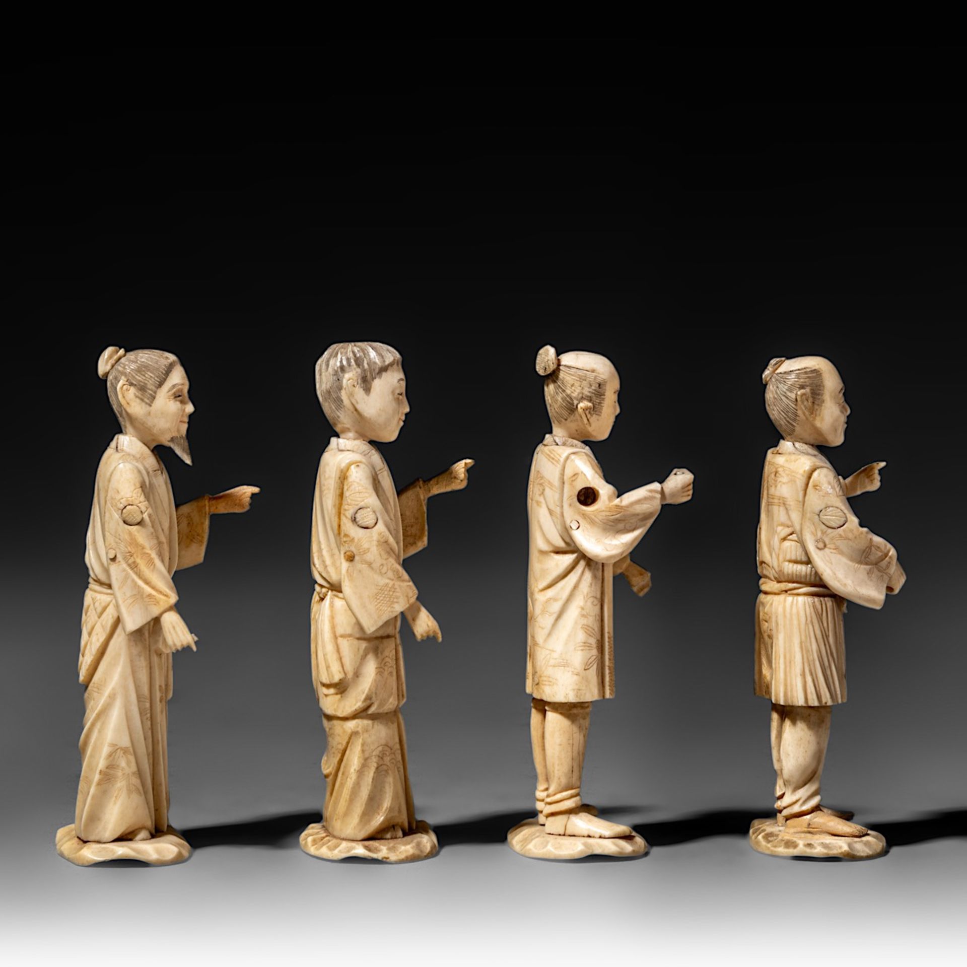 Four Japanese bone okimono, the figures possibly representing different classes in society, on a woo - Image 5 of 7