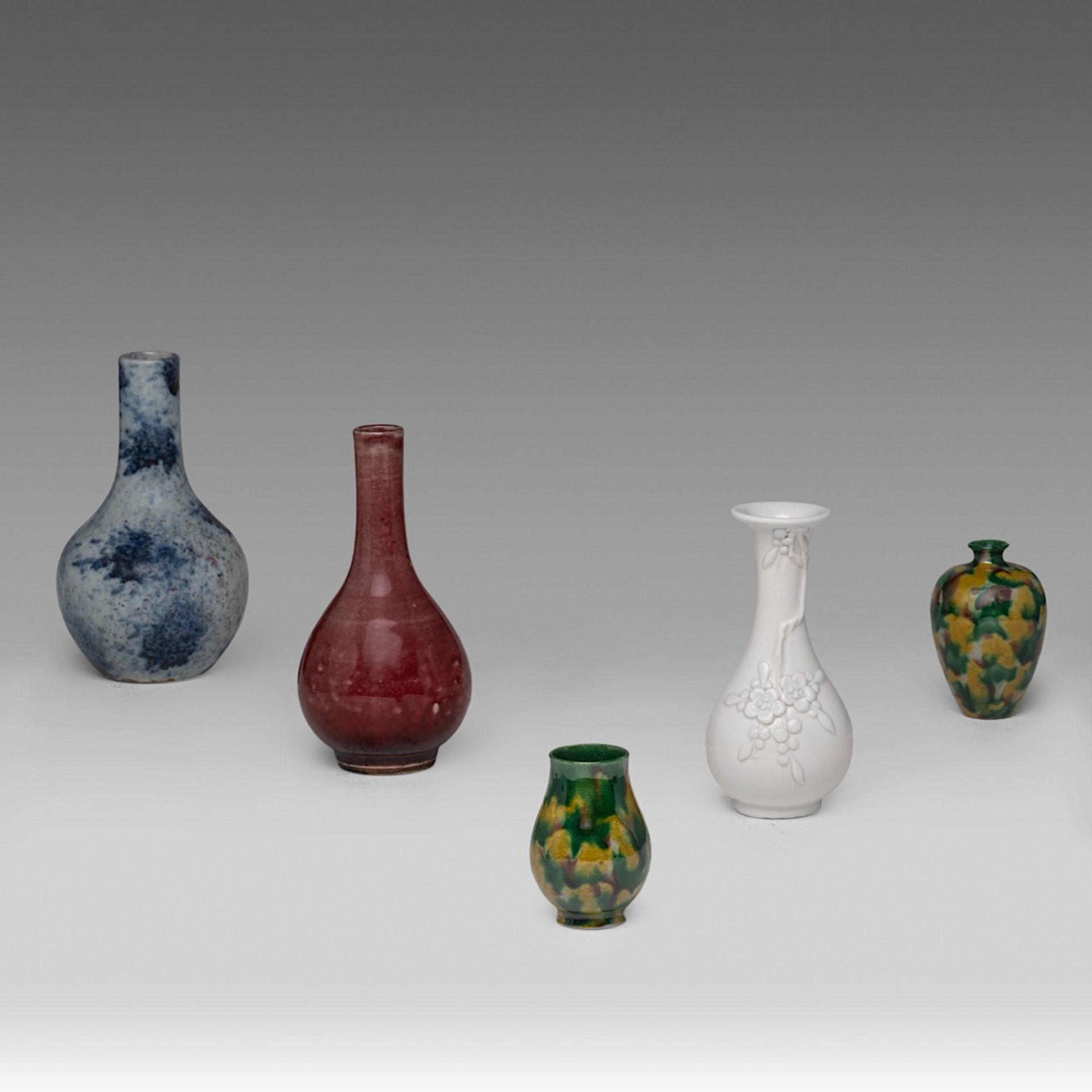 A collection of five Chinese monochrome glazed miniature vases, including a copper red and underglaz
