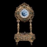 An Austrian gilt-silver and enamel clock with music box, decorated with semi-precious stones and mot