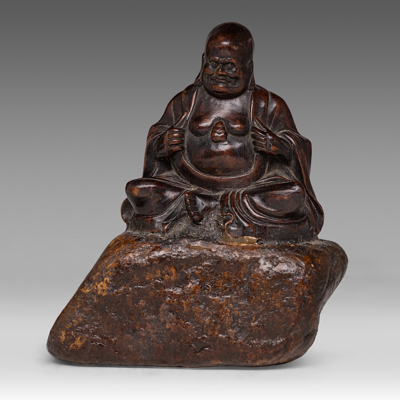 A finely carved wooden figure of 'Open Heart Gobaka Arhat (Luohan)', fixed on rock work, 18thC/19thC
