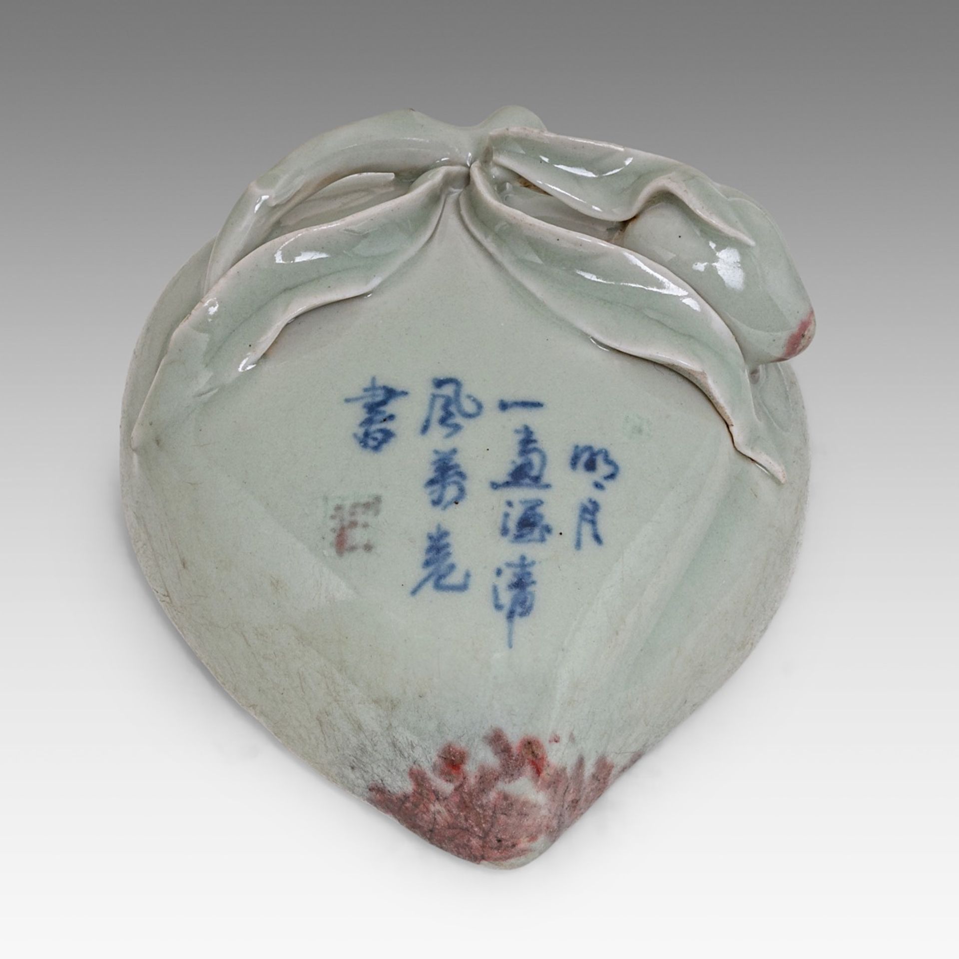 A Chinese copper-red and underglaze blue on celadon ground 'Peach' wall vase, with a Qianlong mark a