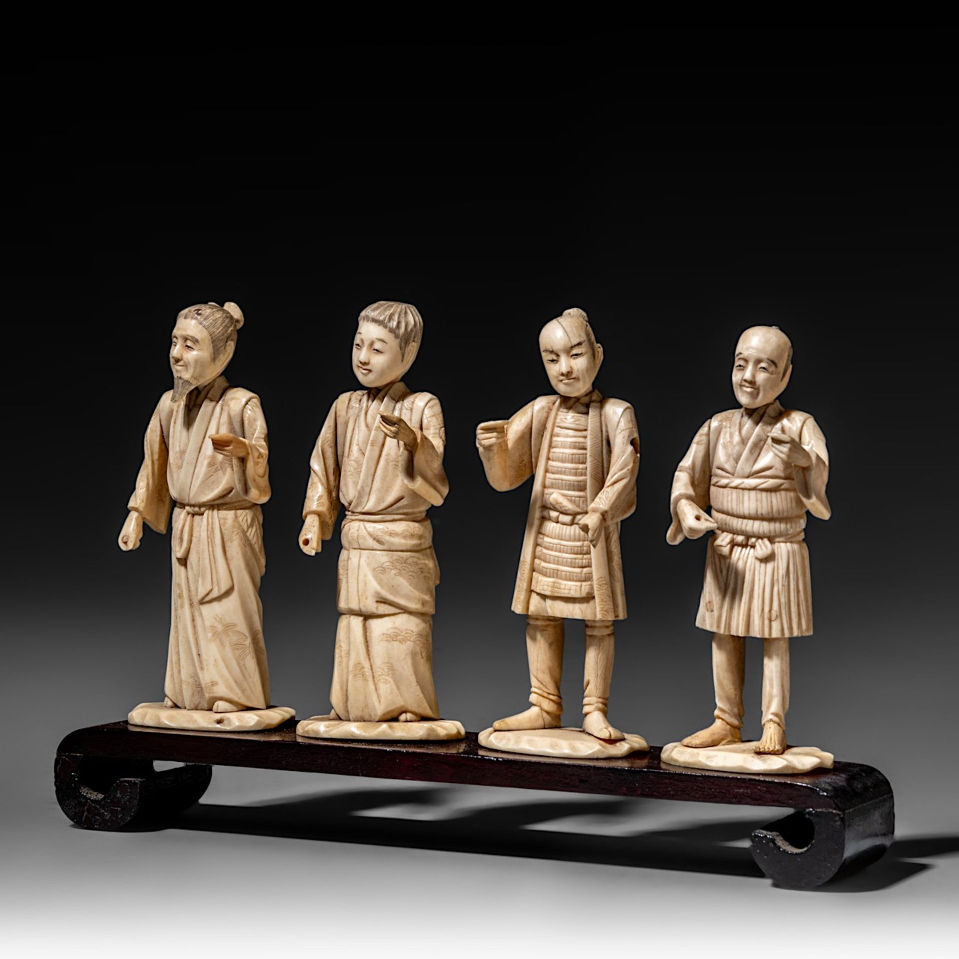 Four Japanese bone okimono, the figures possibly representing different classes in society, on a woo - Bild 2 aus 7