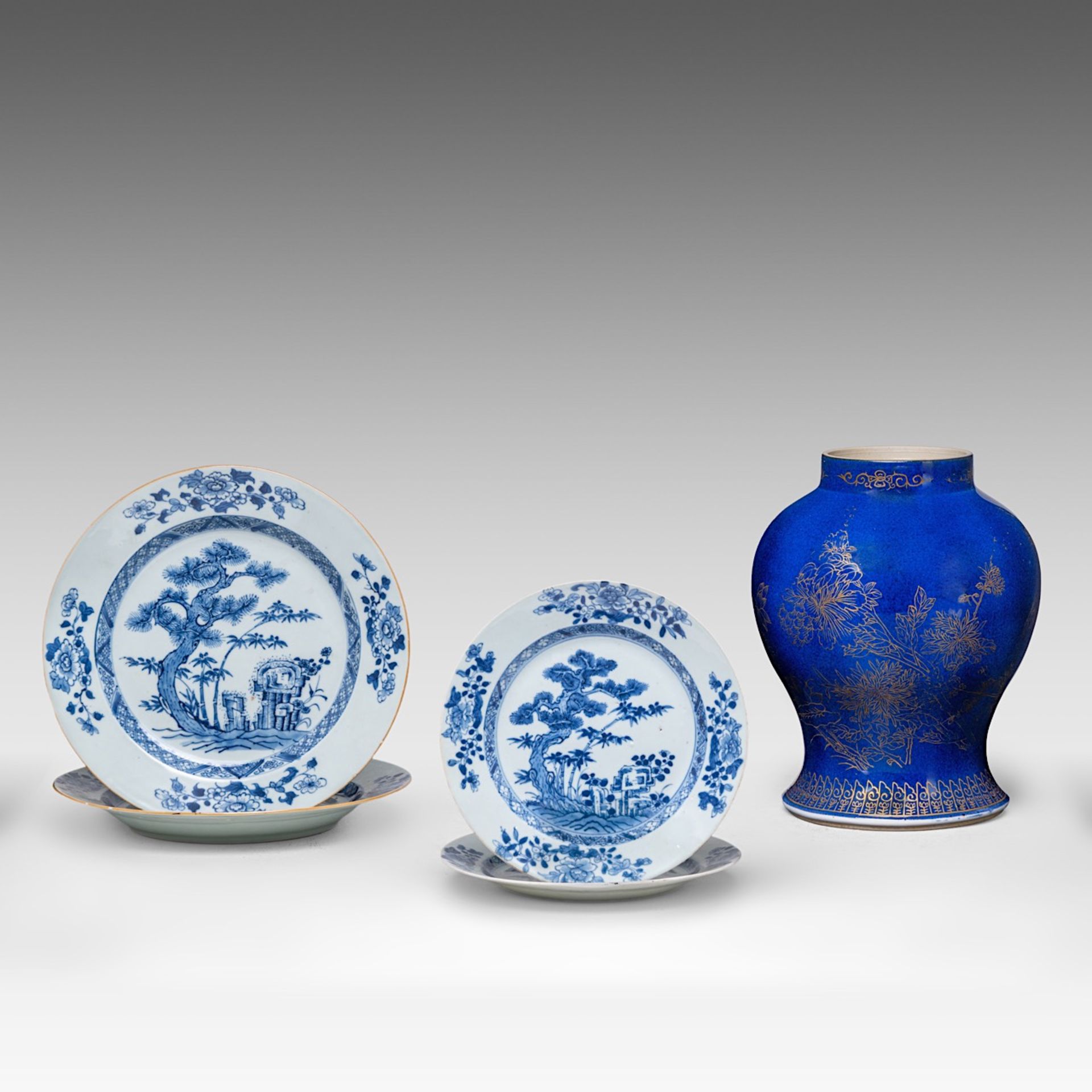 A series of four Chinese blue and white 'Bamboo below Pine' dishes and plates, 18thC, dia 22,5 - 28,