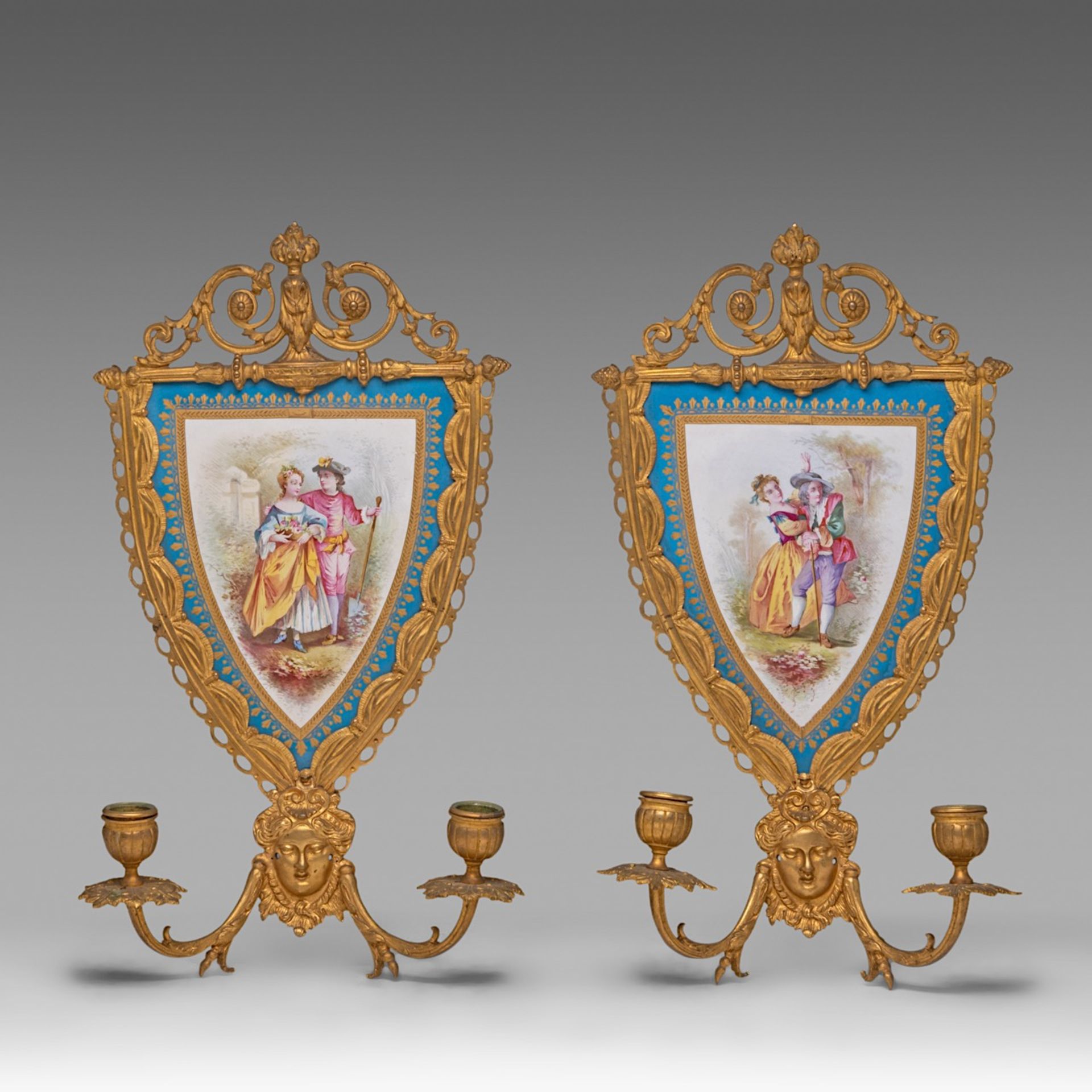 A pair of Louis XVI style Sevres porcelain and gilt bronze wall appliques, H 42 cm