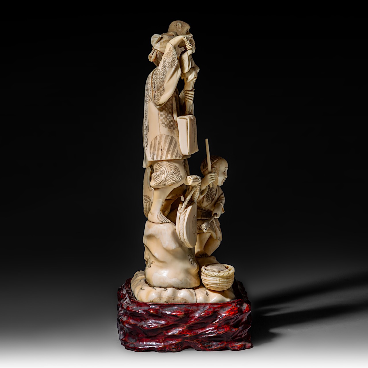 A large Japanese walrus ivory okimono of a musical family, Meiji period (1868-1912), H 26 cm - 1906g - Image 6 of 12