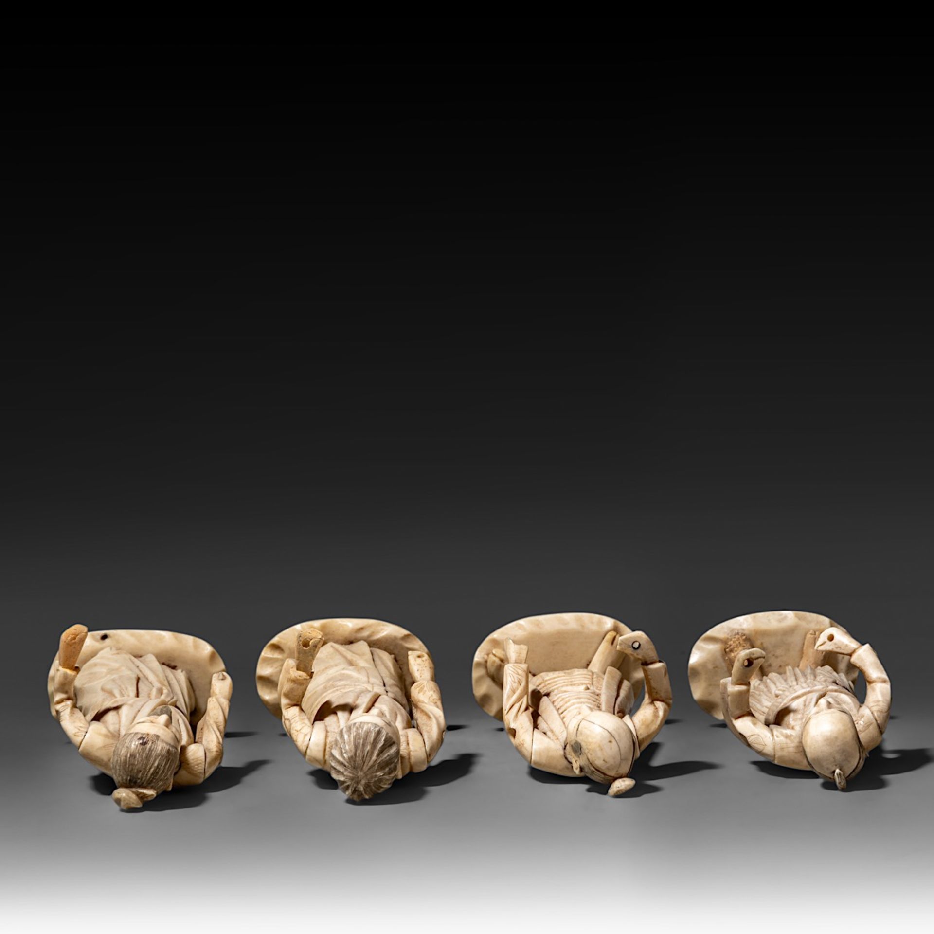 Four Japanese bone okimono, the figures possibly representing different classes in society, on a woo - Image 6 of 7