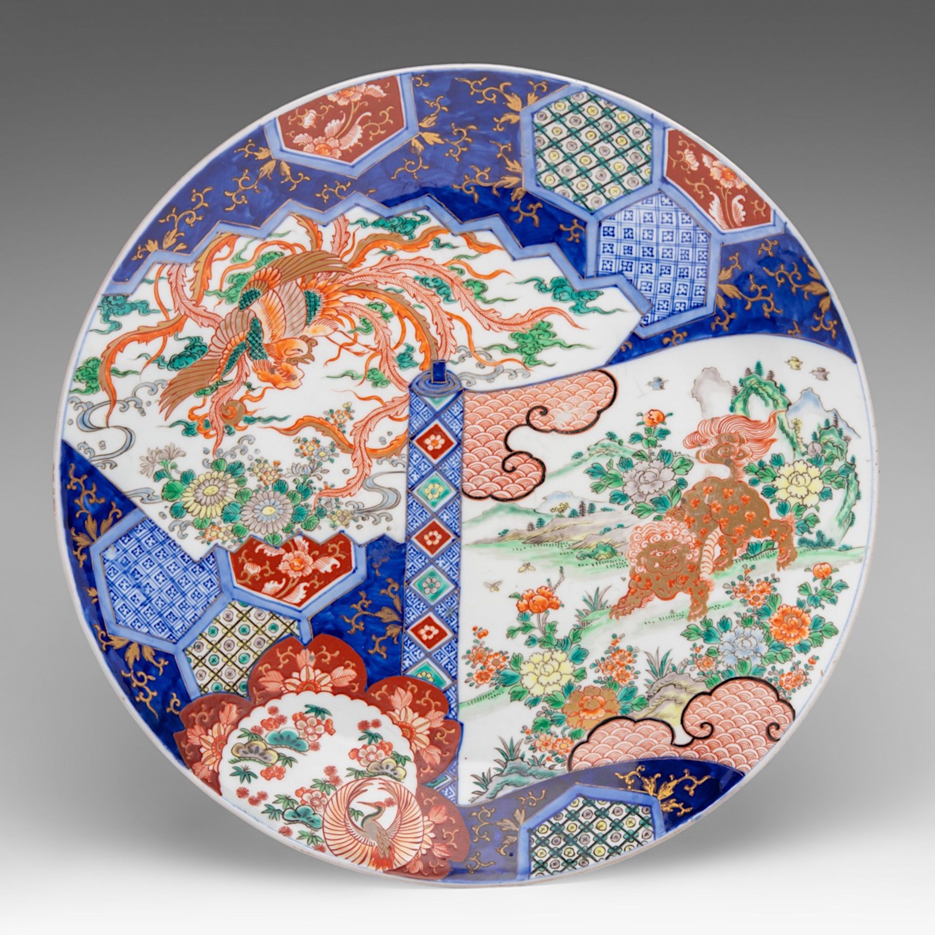A large Japanese Imari 'Shi Shi and Phoenix' plate, late Meiji (1868-1912), dia 55 cm