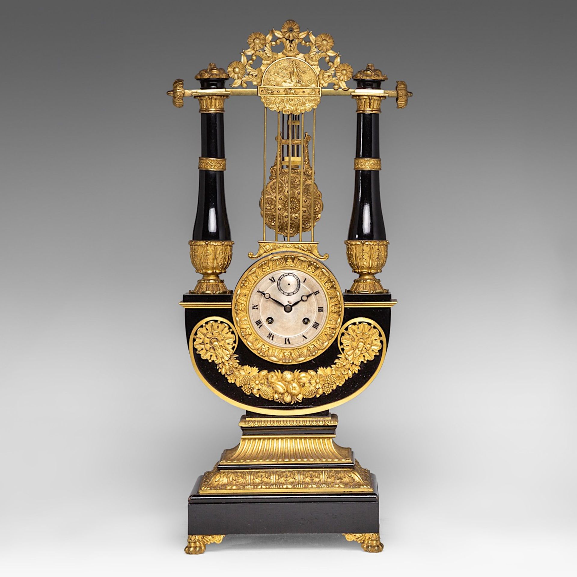 A French Restoration black lacquered and gilt bronze mounted lyre-shaped mantle clock, H 58 cm
