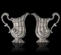 Two (19thC)- 20th-century silver turbo shell-shaped ewers, indecipherably hallmarked, H 25,5 - 26 cm