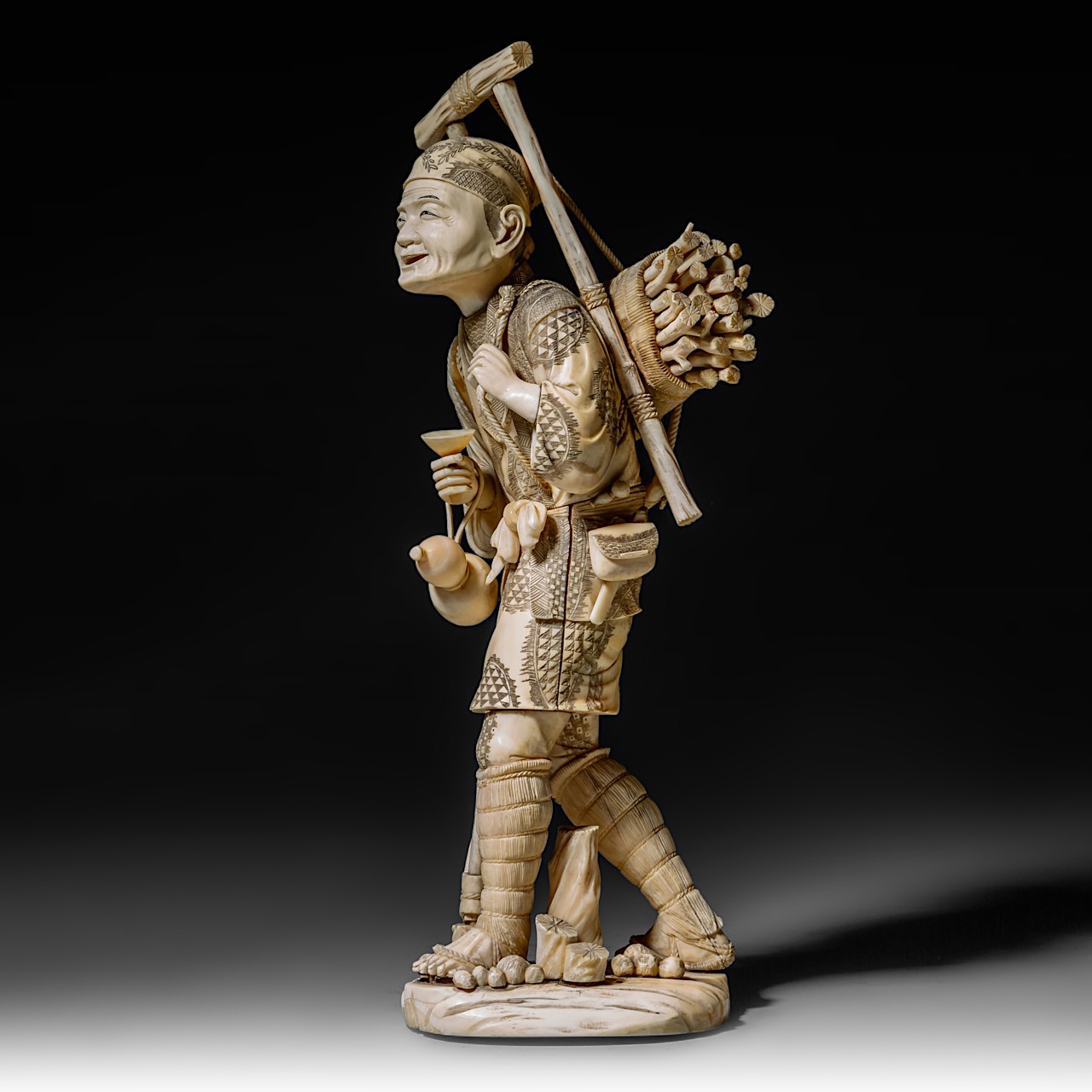 A large Japanese walrus ivory okimono of a wood gatherer, Meiji period (1868-1912), H 38 cm - 2248g - Image 3 of 9