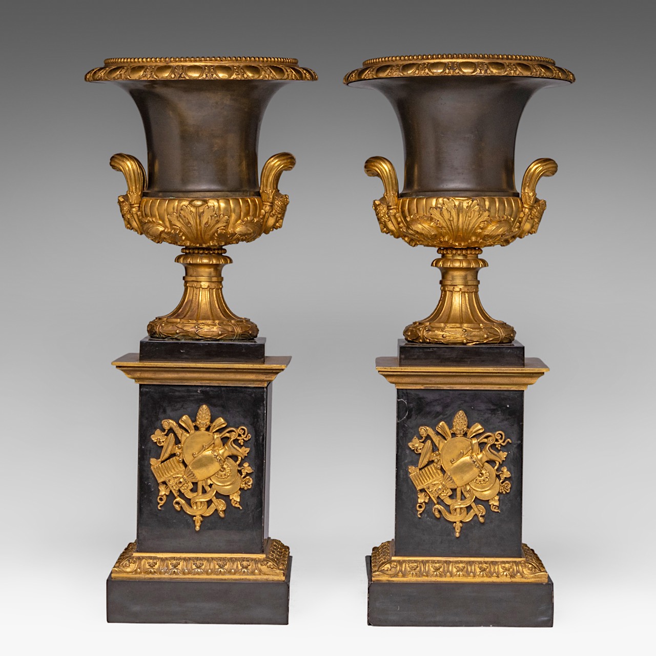 A fine pair of Neoclassical patinated and gilt bronze and black marble Medici type vases, H 45 cm