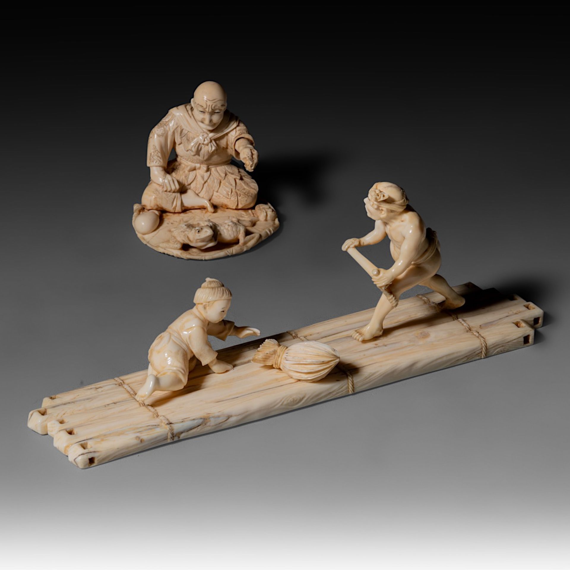 Two Japanese Meiji-period (1868-1912) ivory okimono; one depicts a man rowing a raft while a child s