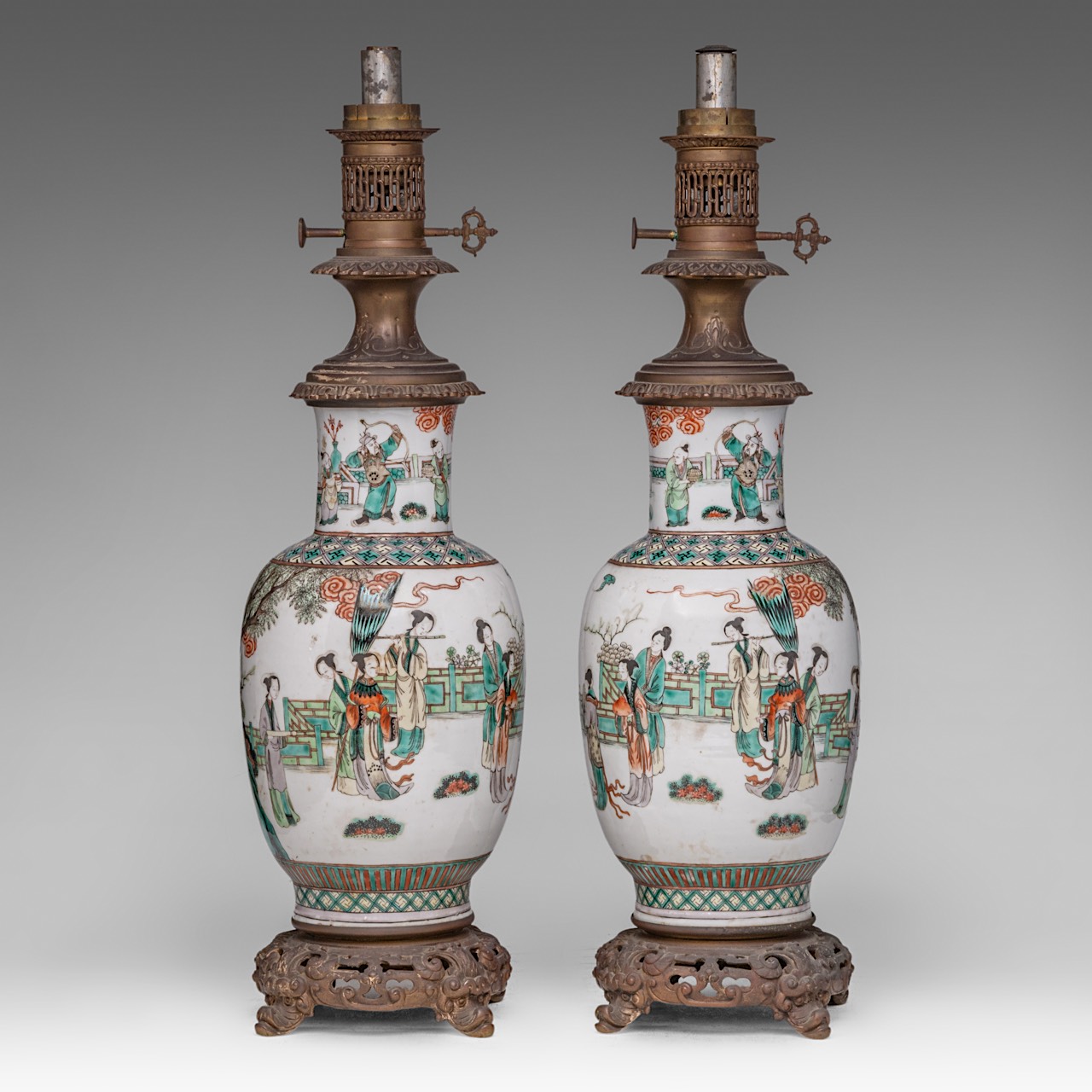 A pair of Chinese famille verte 'Immortals in a Garden' vases, fixed with lamp mounts, late 19thC, T