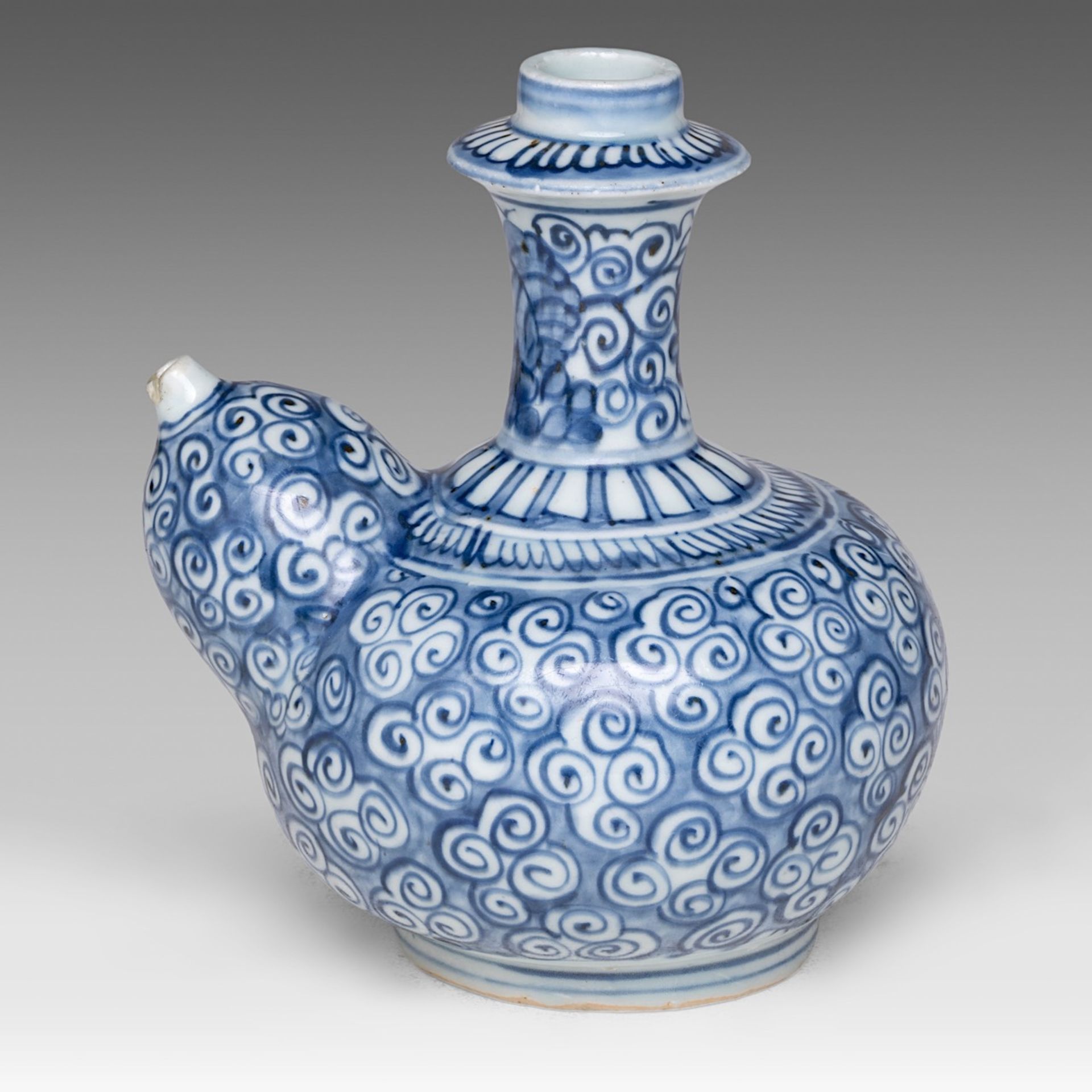 A Chinese blue and white Kendi jug decorated with scrolling tendrils, marked with a rabbit, 17thC, H - Image 3 of 7
