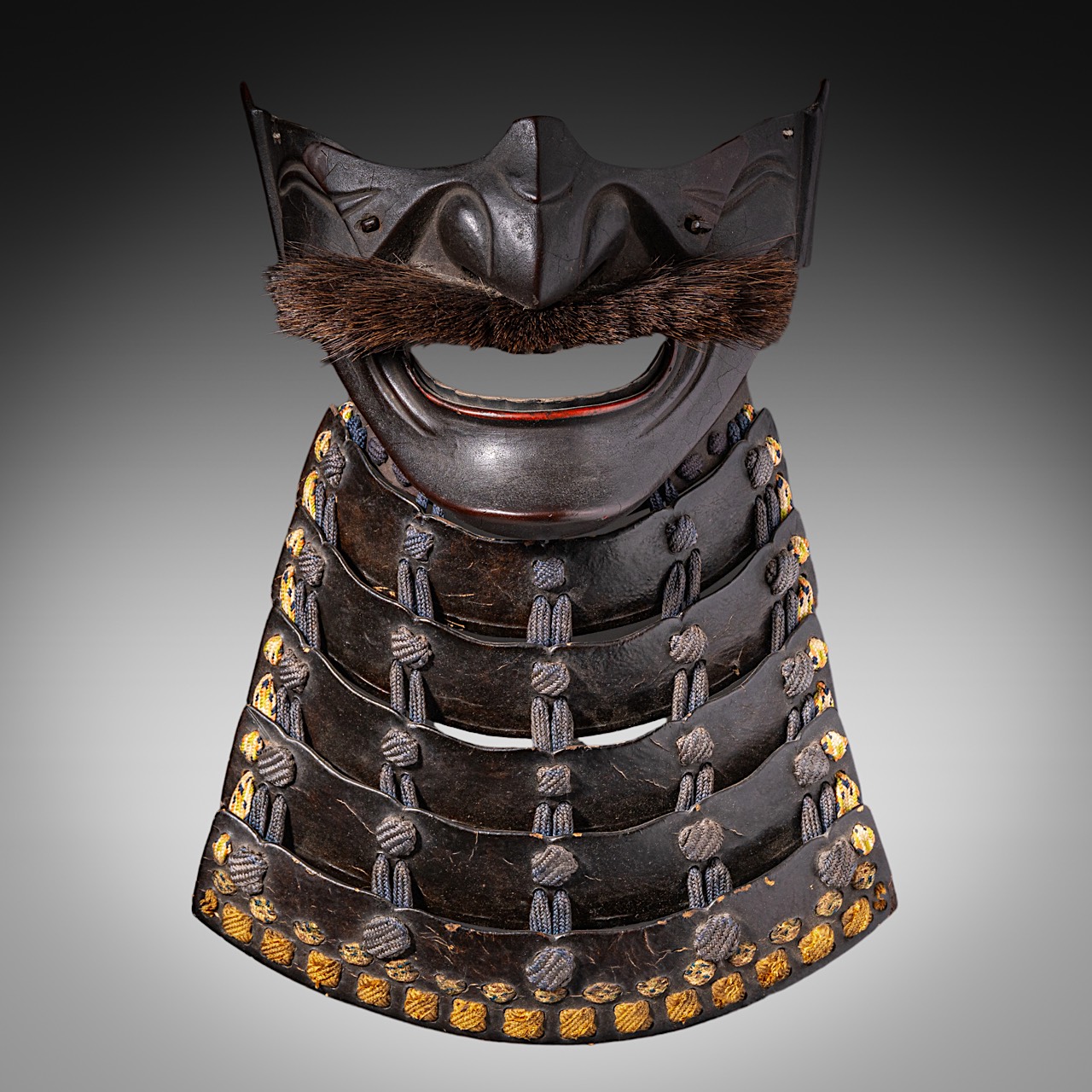 A Japanese late Edo/Meiji period (19thC) menpo (face guard for samurai armour), metal, leather and l