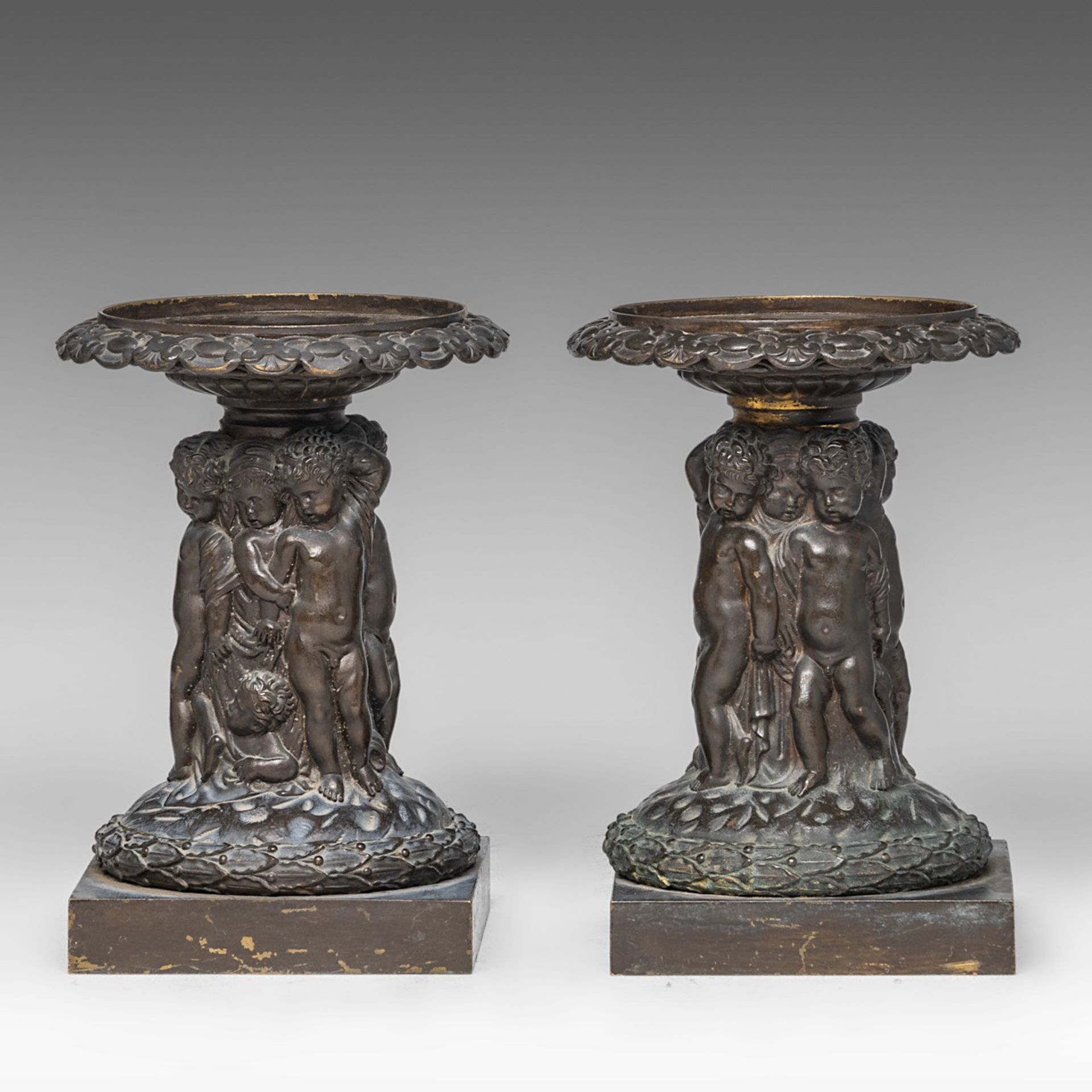 A pair of cut crystal coupes on patinated bronze figural stands, in the Wiener Werkstatte manner, H