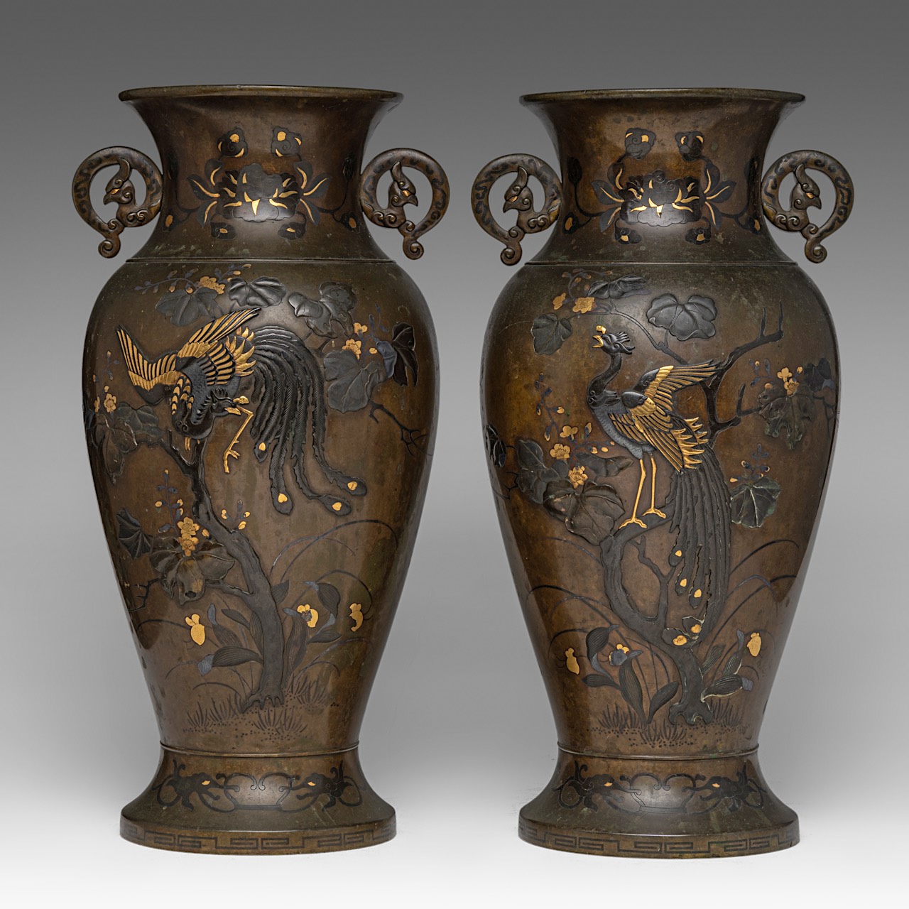 A pair of Japanese bronze 'Phoenix' vases with gilt details, Meiji period (1868-1912), both H 41,5 c