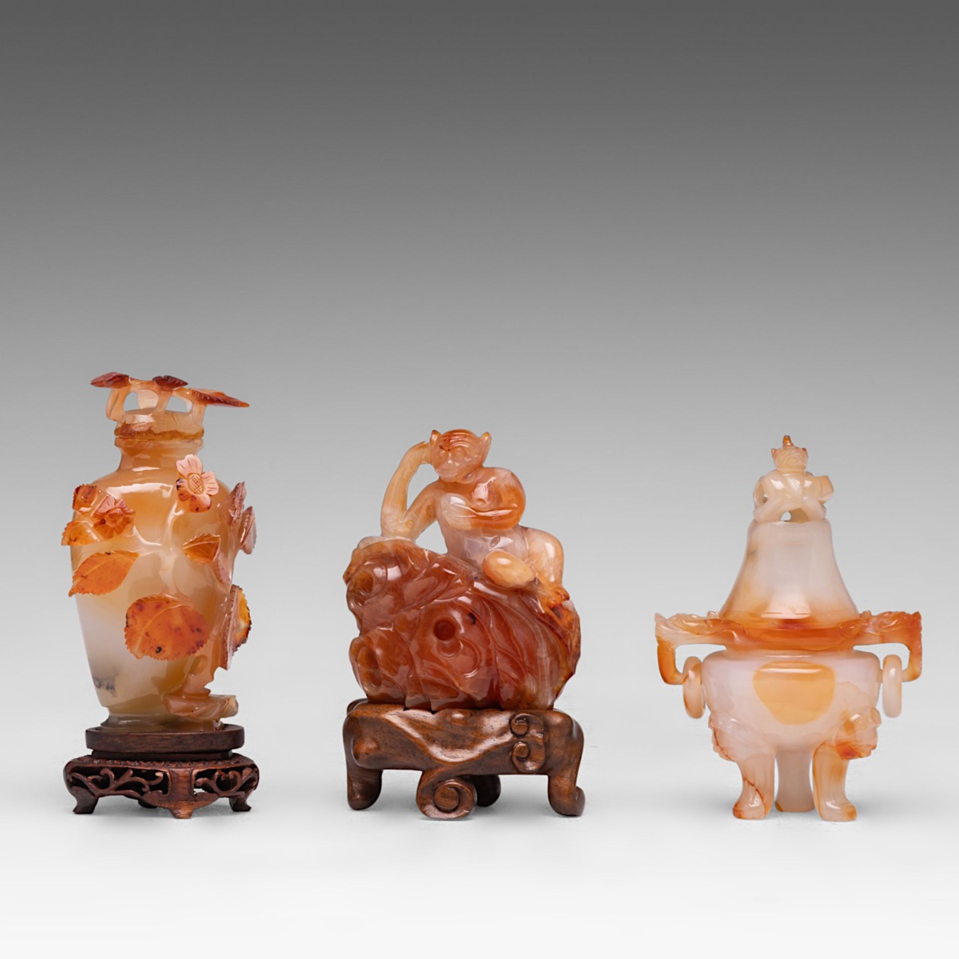 Three Chinese carnelian agate carvings: a tripod censer and cover, a 'Prunus' snuff bottle, 'Monkey