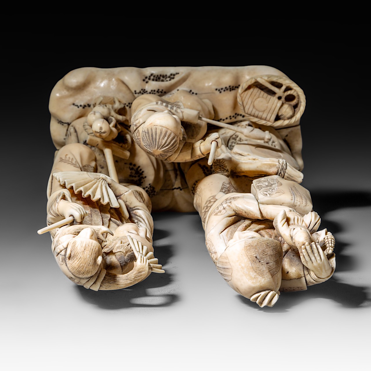 A large Japanese walrus ivory okimono of a musical family, Meiji period (1868-1912), H 26 cm - 1906g - Image 8 of 12