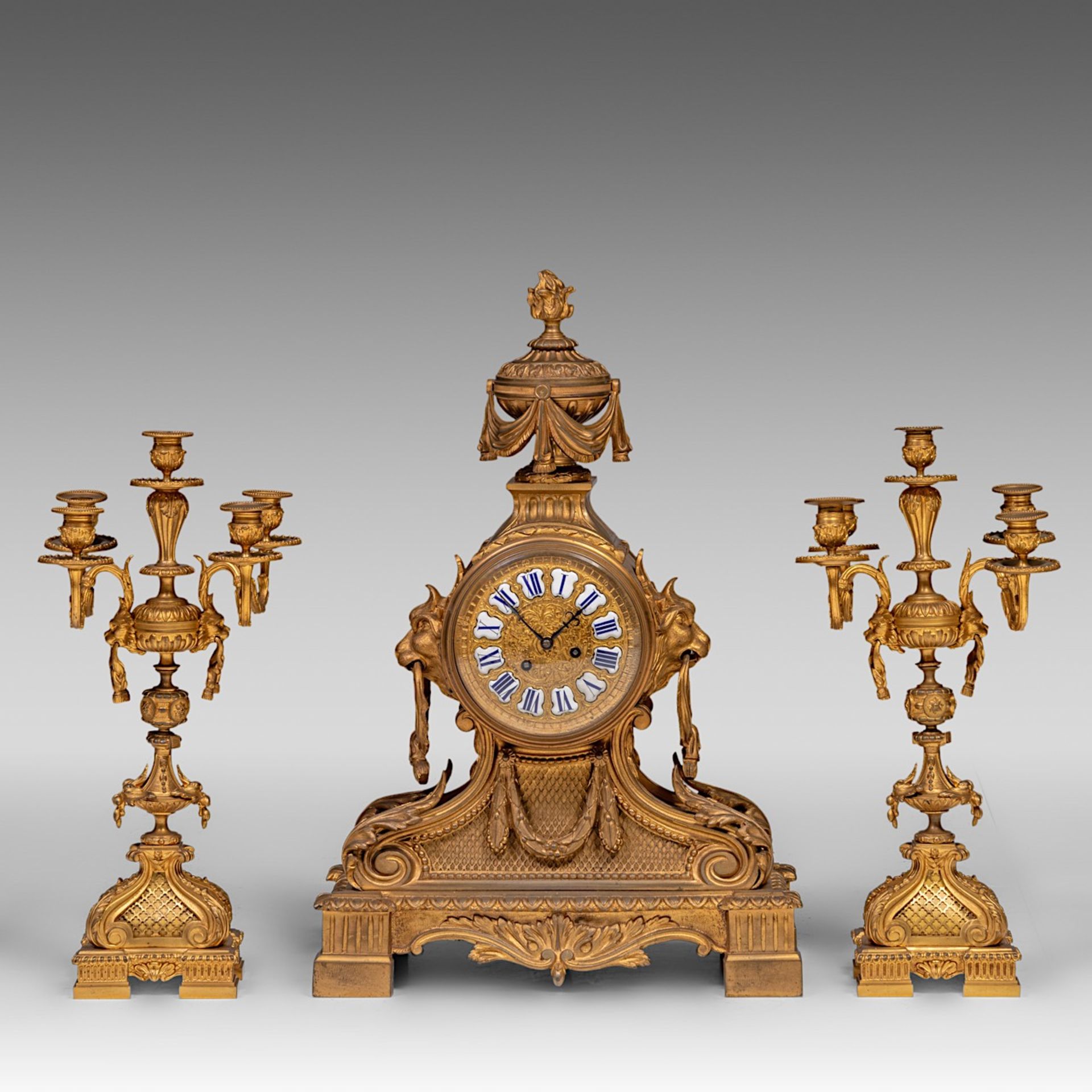 A three-piece Neoclassical gilt bronze mantle clock, H 50 - 65 cm