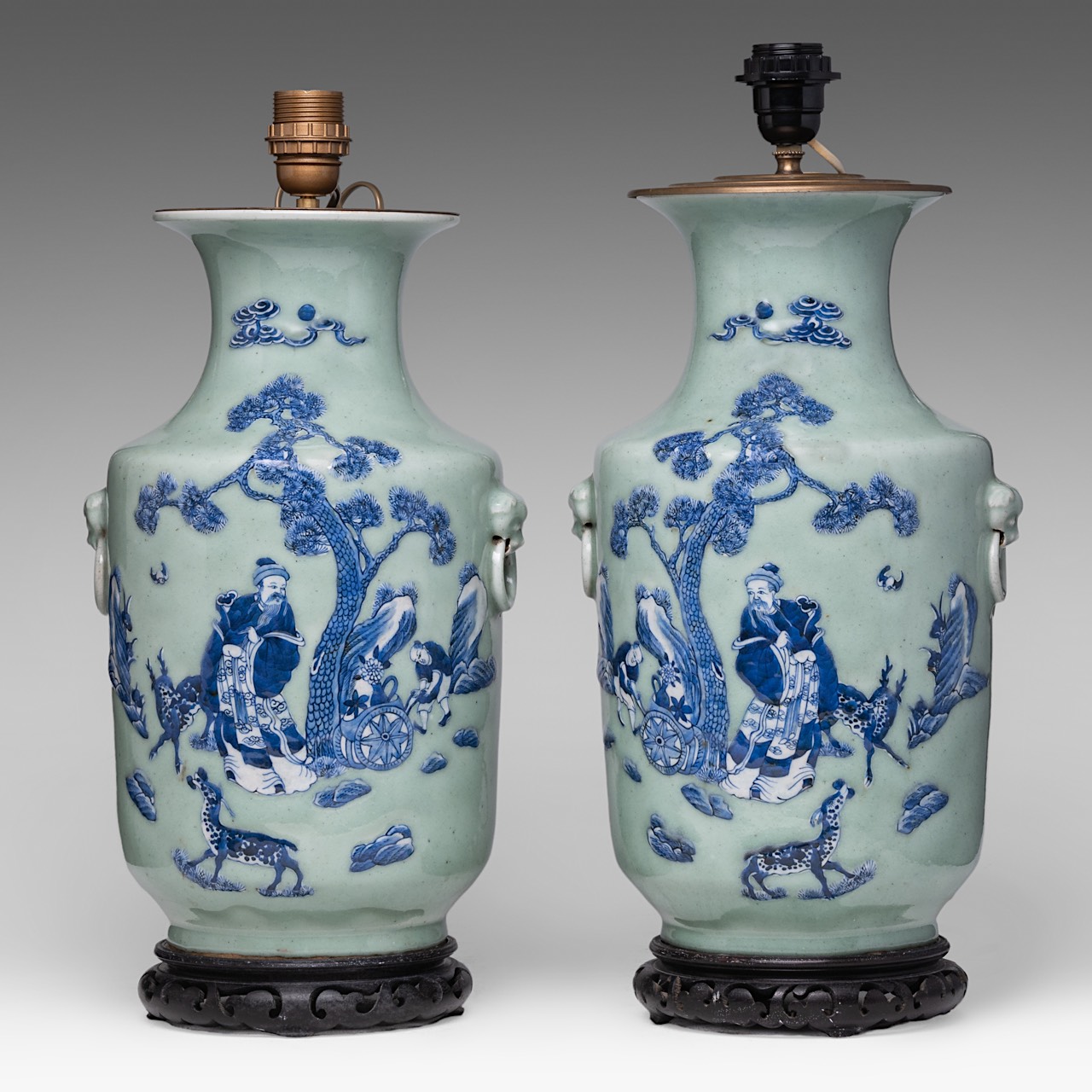 A pair of Chinese blue and white on celadon ground 'Immortal' vases, fixed with lamp mounts, total H