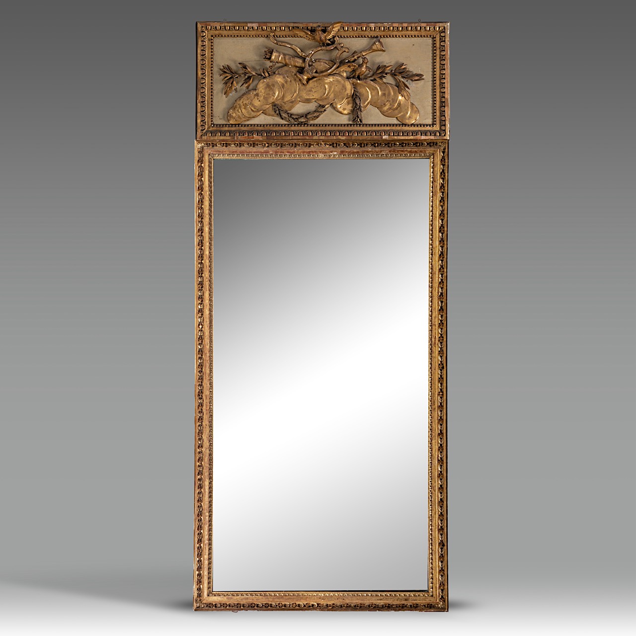 A Louis XVI giltwood trumeau mirror, decorated with a trophy on top, H 270 - W 118 cm
