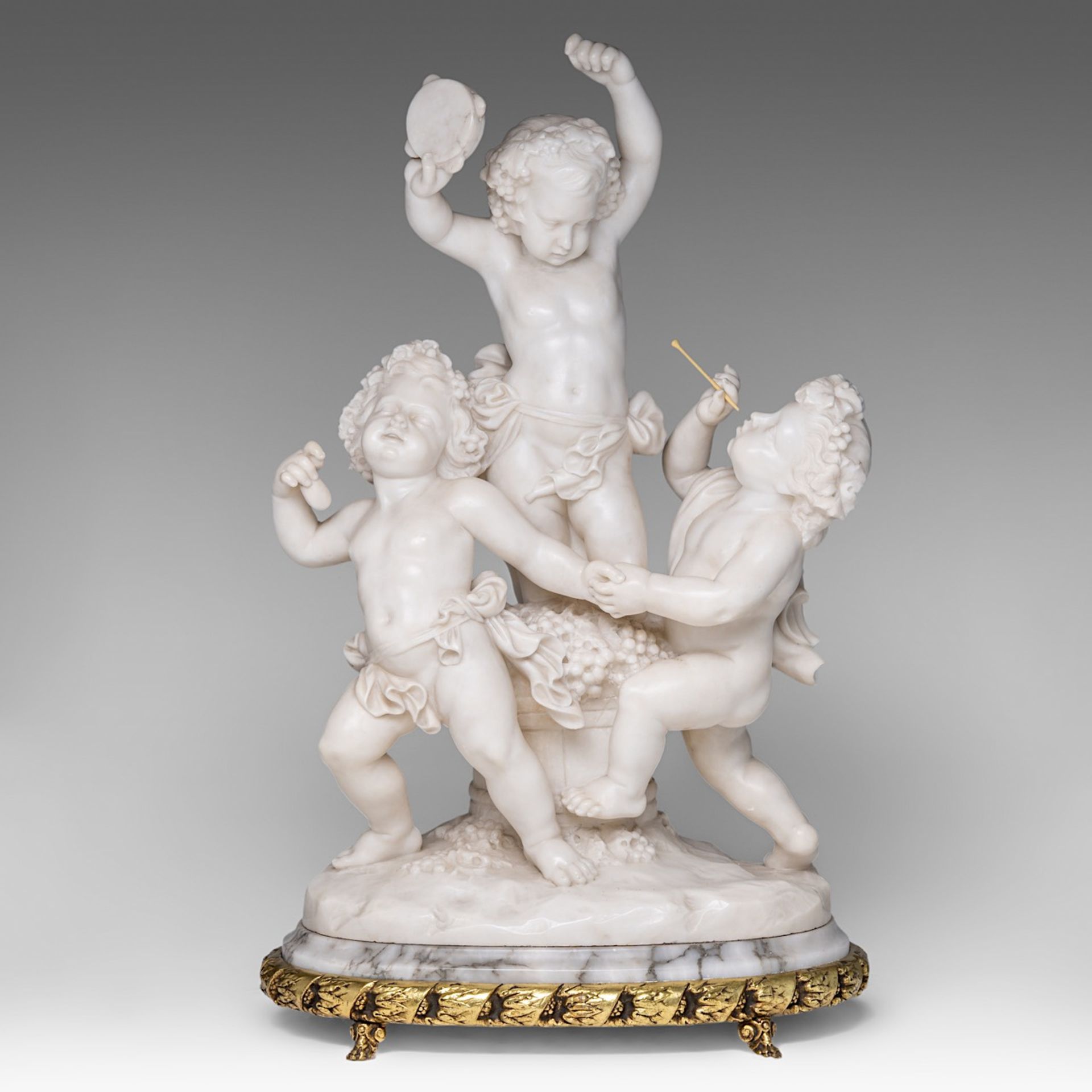 A charming alabaster group of playing putti, on a gilt brass stand, H 68 cm (total)