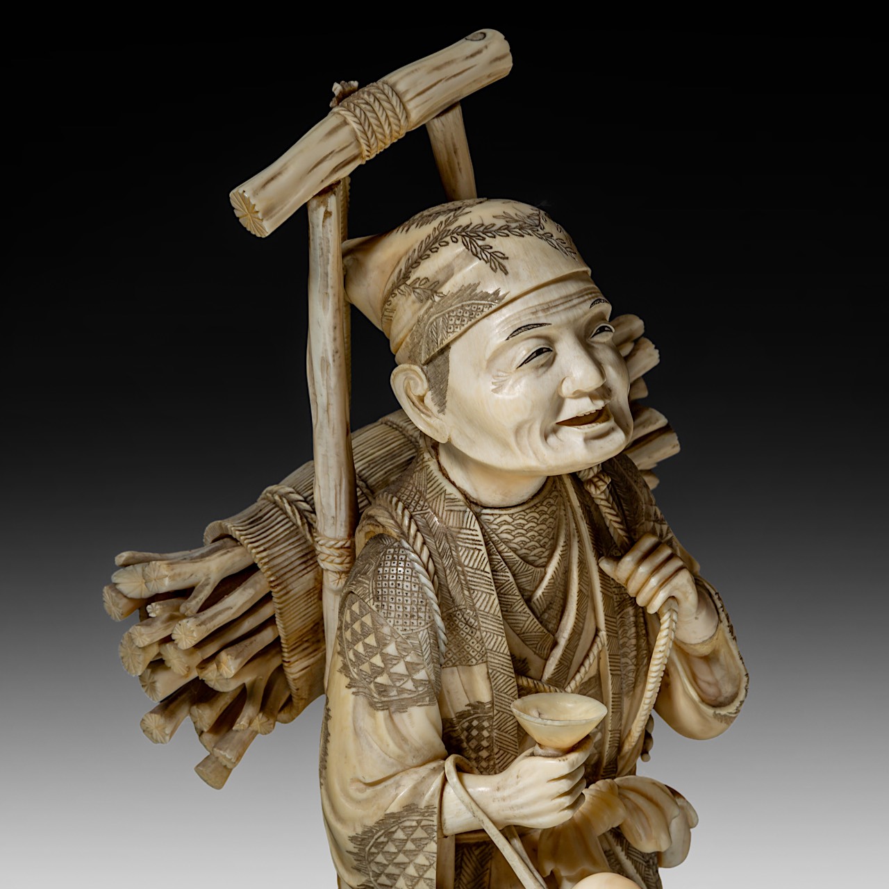 A large Japanese walrus ivory okimono of a wood gatherer, Meiji period (1868-1912), H 38 cm - 2248g - Image 9 of 9