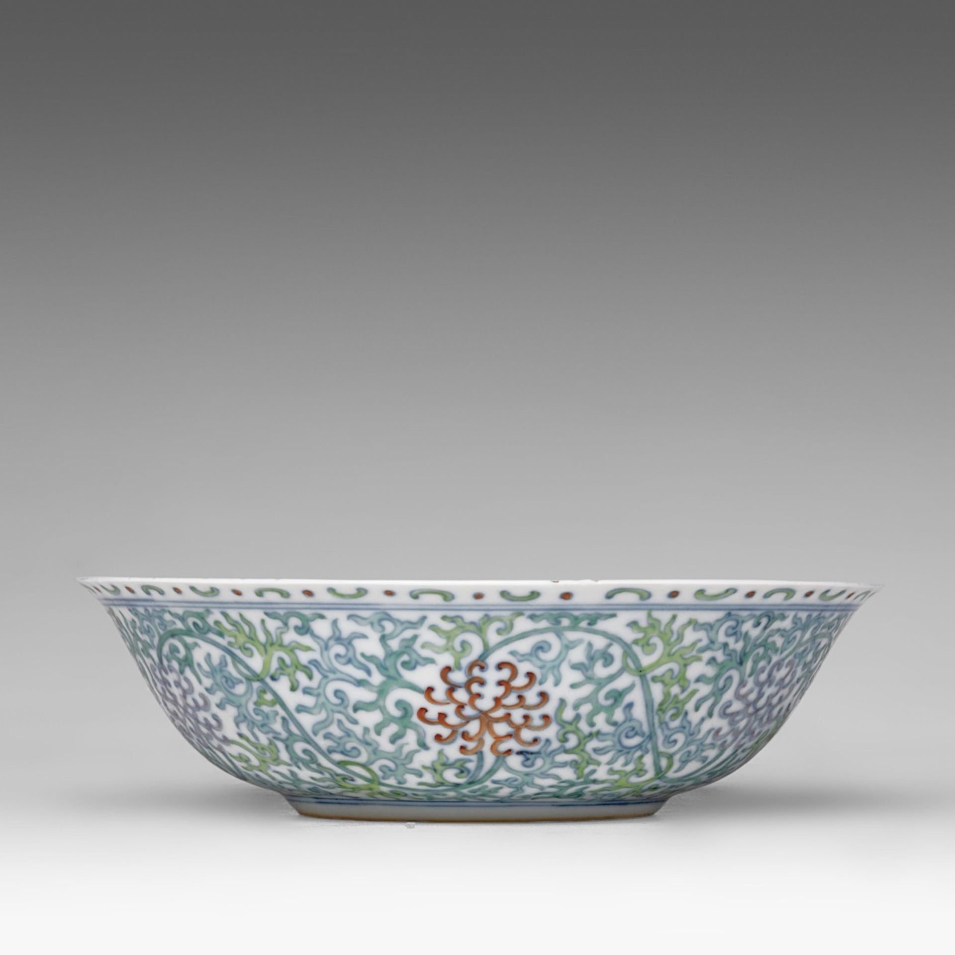 A Chinese doucai 'Scrolling Chrysanthemum' deep plate, Guangxu mark and of the period, dia 23 cm