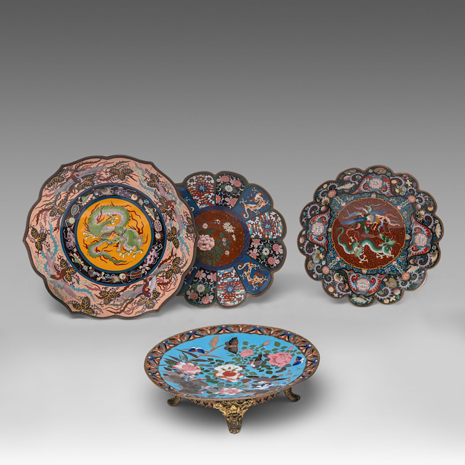 A collection of four Japanese cloisonne enamelled plates, one fixed on a gilt bronze foot, 20thC, di