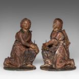 An exceptional pair of 16thC polychrome terracotta angels holding a pricket candlestick, H 38-39 cm