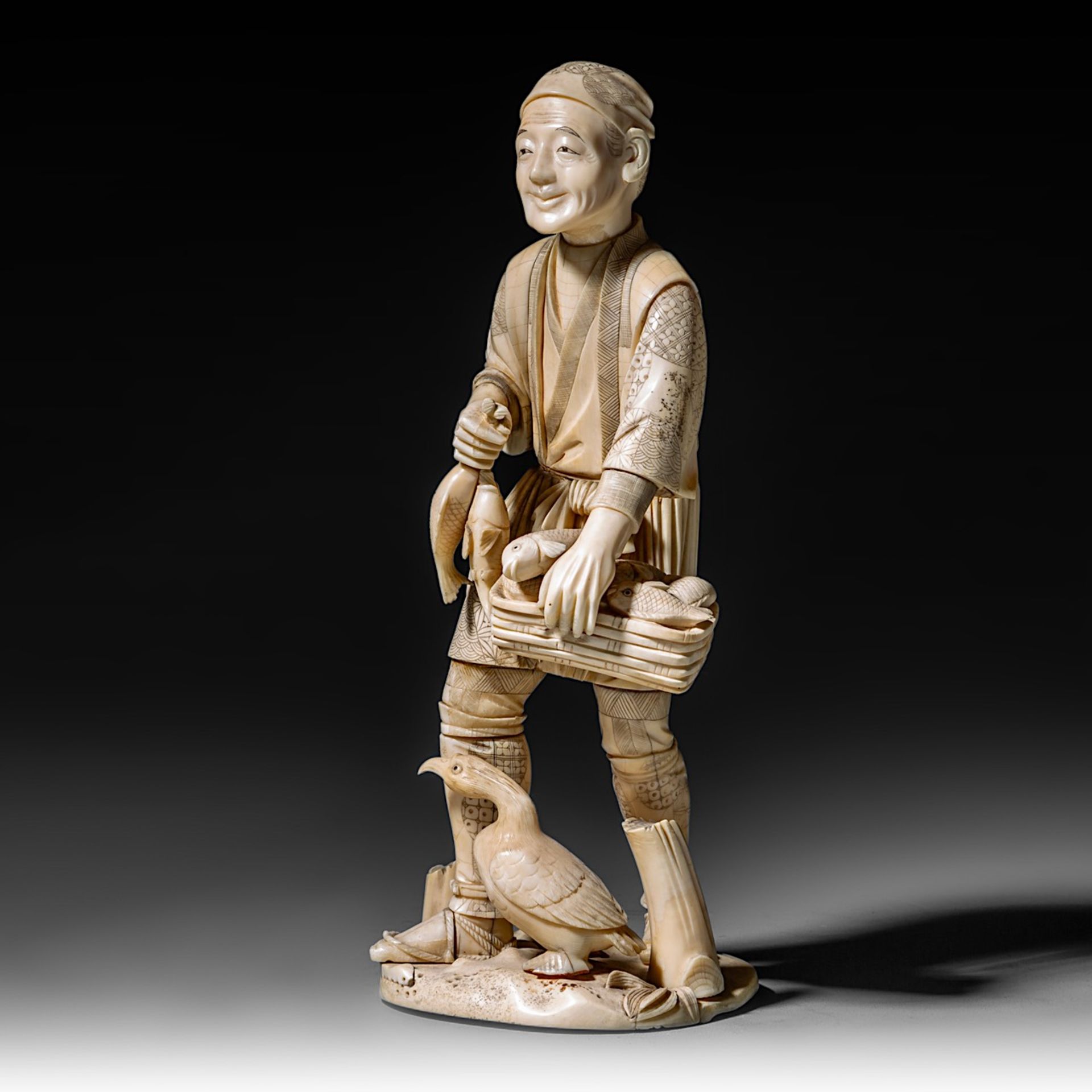 A Japanese hippo and walrus ivory okimono of a man selling fish, Meiji period (1868-1912), H 28,5 cm - Image 2 of 10