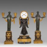 An Empire figural mantle clock, and two matching candelabras, H 43 - 44 cm