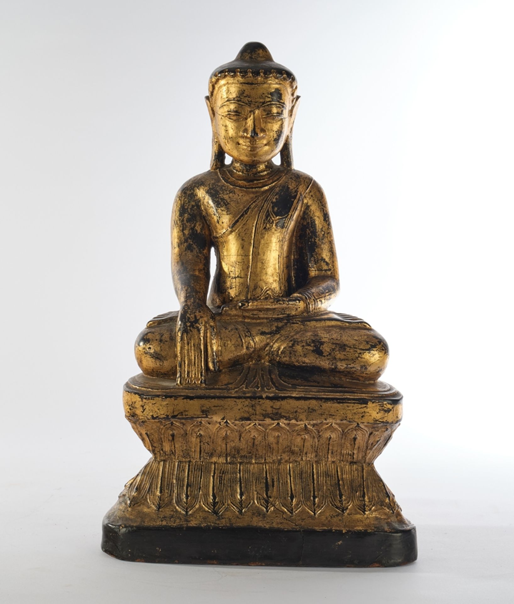 Buddha, Burma, 19th century, wood, carved, painted black and gilded, seated in meditation on a plin