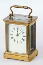 Travel clock, brass case glazed on all sides with faceted discs, open balance on top, h. 11 cm excl