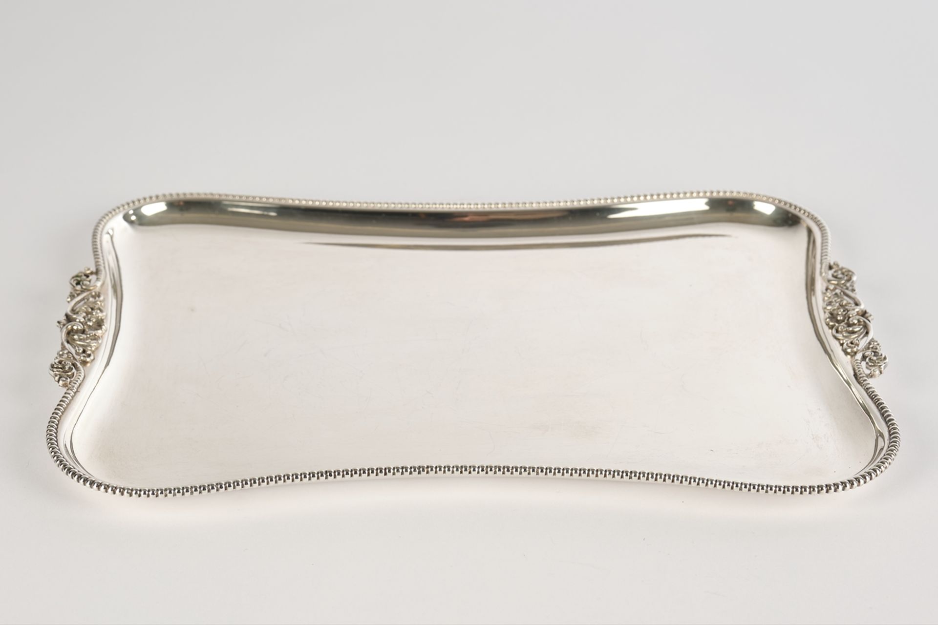 Tablet, 800 silver, Italy, of moulded rectangular form on all sides, beaded rim, handles with scrol