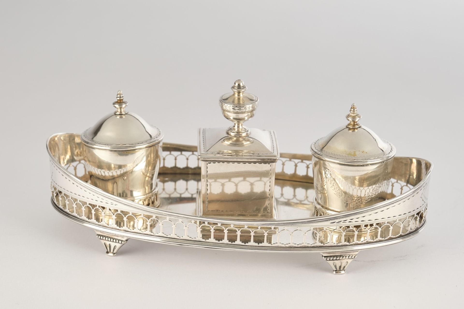 Desk set, silver, 19th century, oval frame with latticework, mounted central lidded box, inkwell in