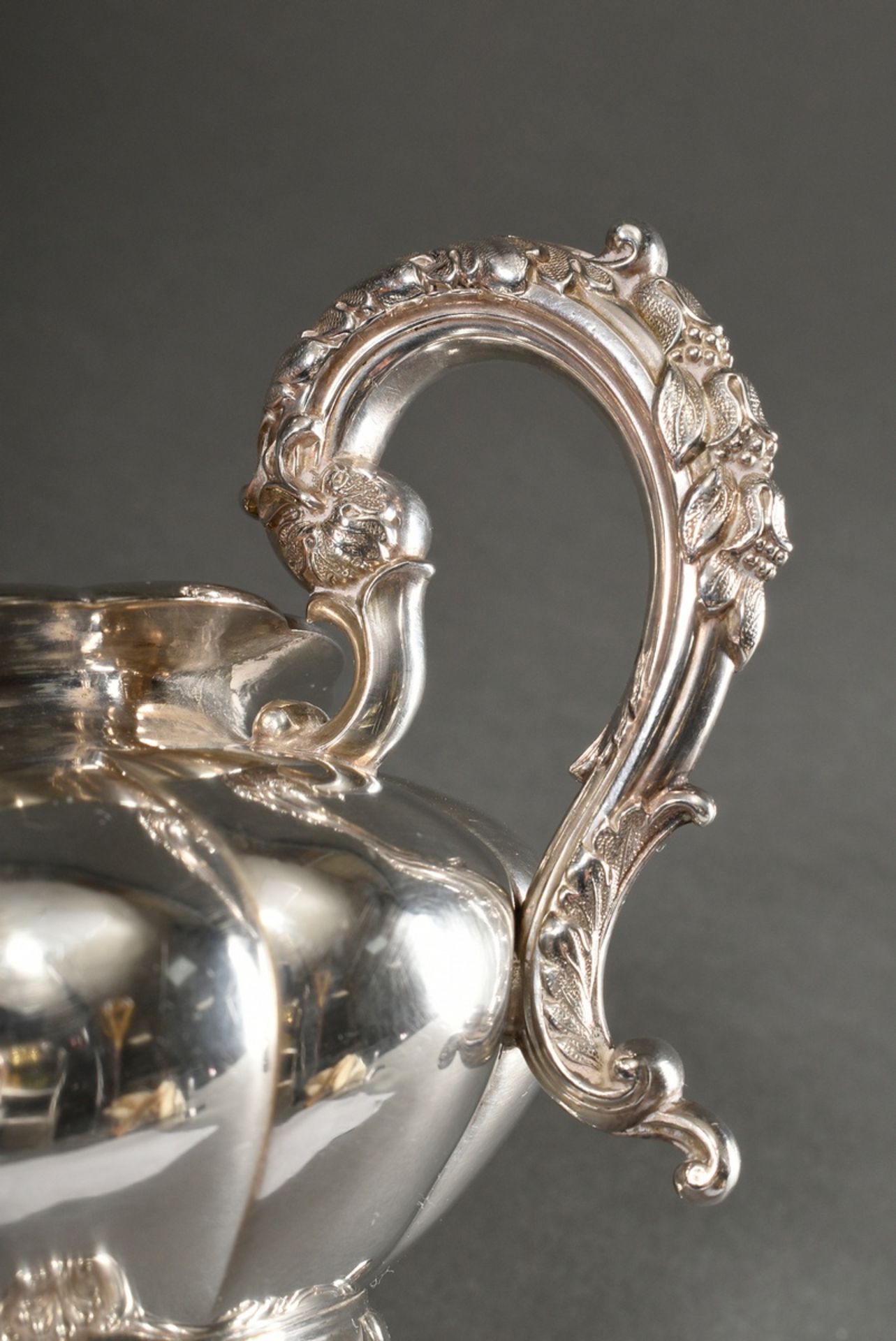 Cambered milk pourer with floral relief rim and feet, engraved family crest "Hand with closed crown - Image 5 of 7