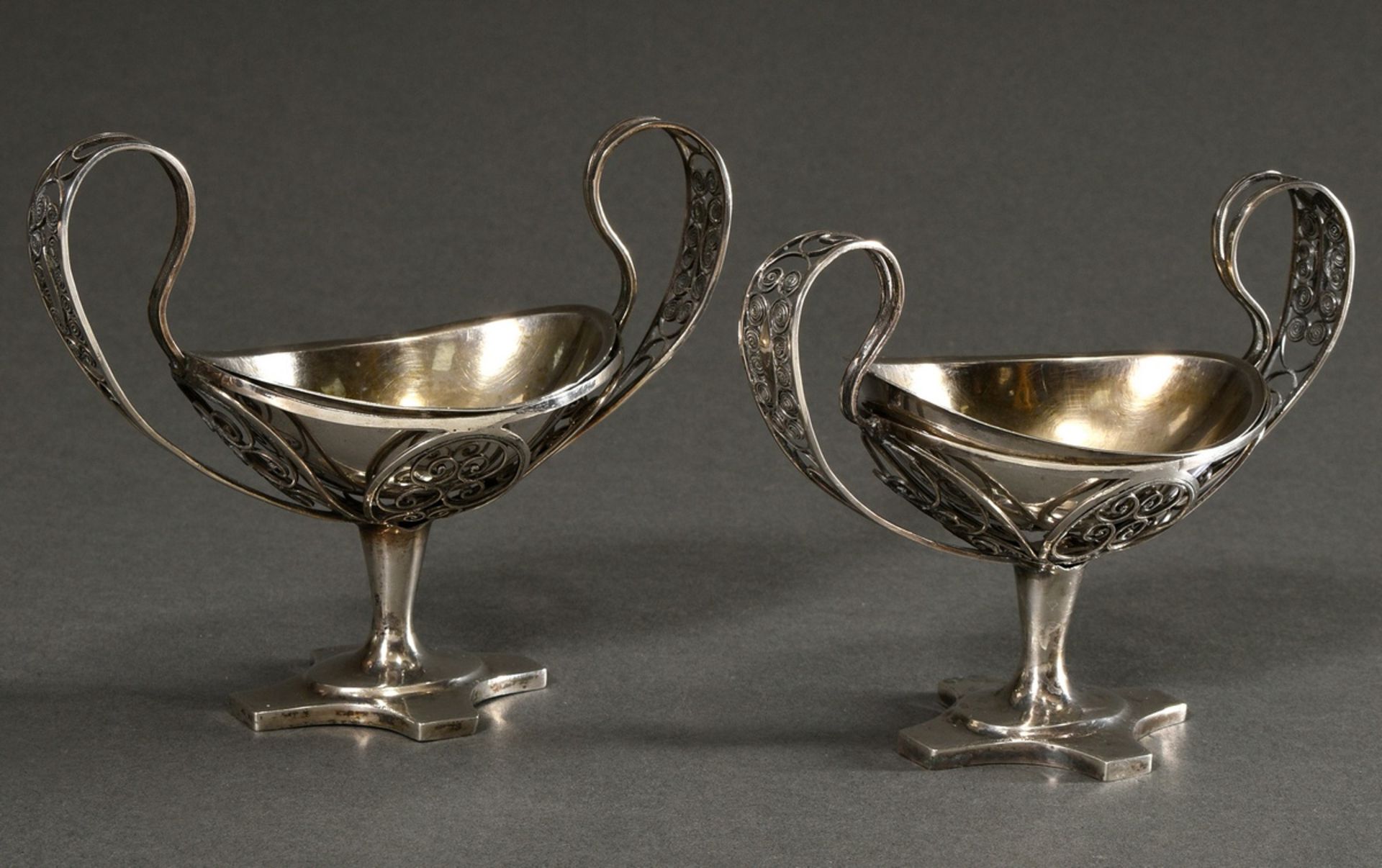 A pair of Empire salvers with filigree bowl and ear handles over a quatrefoil foot, removable inser
