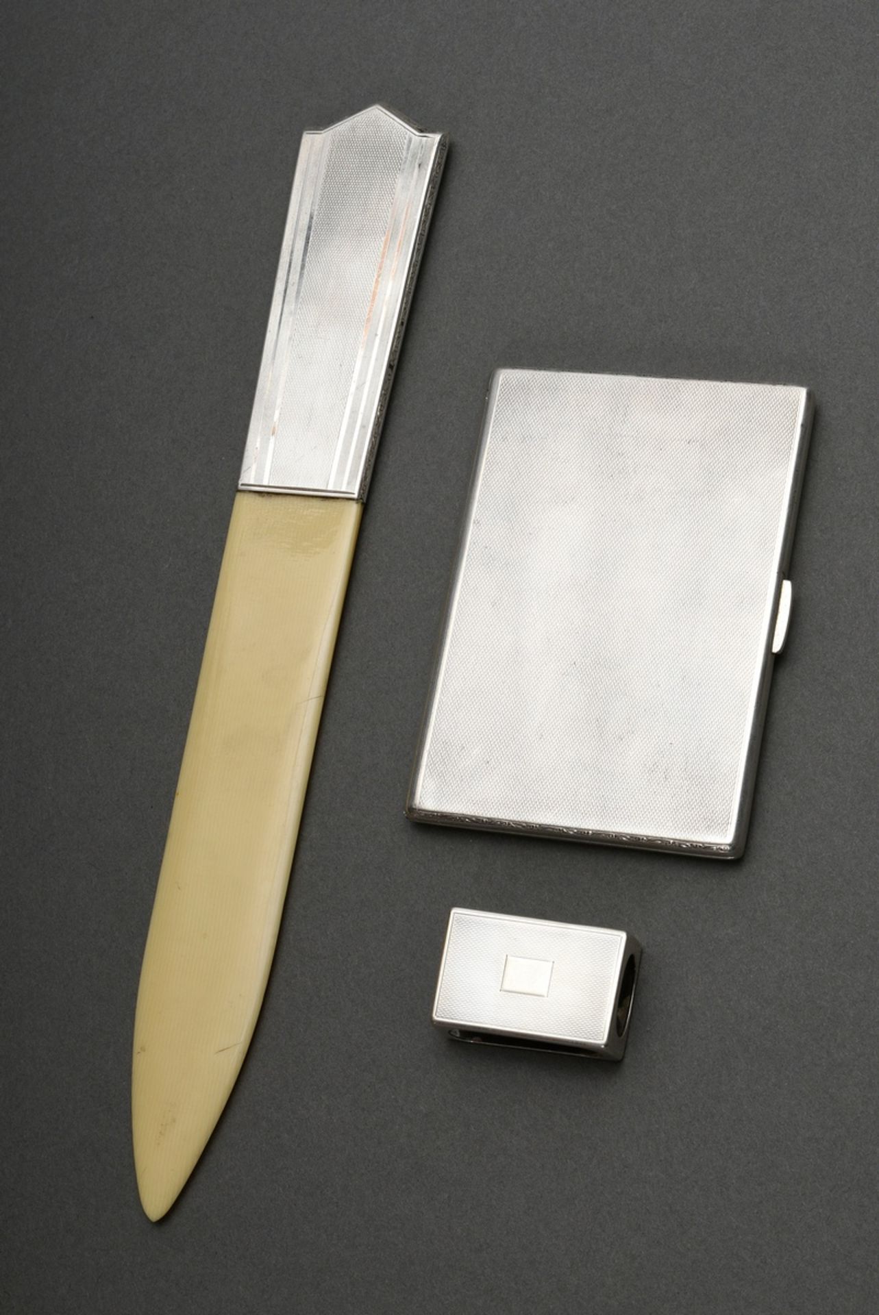 3 Various pieces of guilloché silver: letter opener with Bakkelit blade (l. 29.5cm), matchbox case,