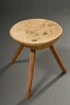 Rustic softwood three-legged stool with moulded seat and inserted legs, h. 42cm