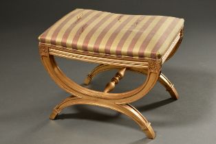 Gilded gondola stool with carved scissor shaped frame in Empire style, rubbed, signs of use