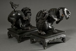 Pair of winding Fo lions on separate plinths, bronze, the forehead marked "Wang" (king), Qing perio