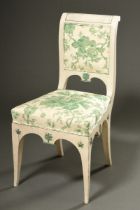 Empire chair on sabre legs with curved backrest as well as star and palmette reliefs on all sides, 