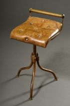 Brass swivel stool with greenish capitoned leather seat in wave form, England c. 1900, h. 53/61.5cm