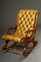 Low fireplace swing chair with capitoned green leather upholstery, England 19th c., h. 30/78